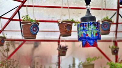 Inside the new garden room at Taj Begum restaurant in Kabul hang plant pots and painted light shades. The restaurant has survived the Covid-19 pandemic but owner Laila Haidari is worried a deal between the Taliban and the Afghan government could put her business in jeopardy. Charlie Faulkner for The National
