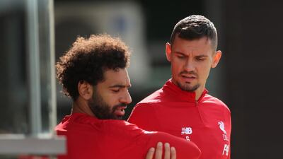 Liverpool's Mohamed Salah and Dejan Lovren walk out to the training pitch at Melwood. Reuters