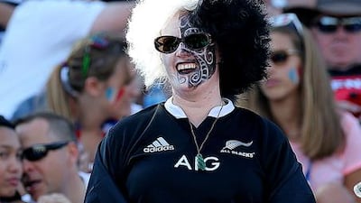 A New Zealand fan gets into the spirit with face paints and a wig at Dubai Rugby Sevens on Friday. Satish Kumar / The National