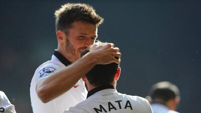 Manchester United's Juan Mata celebrates with Michael Carrick after scoring his second goal for the club on Sunday in a win over Liverpool. Peter Powell / EPA
