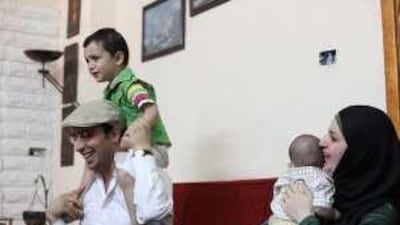 Islam Samhan plays with his son Ward at his home in Zarqa, Jordan. He expects to soon begin serving a one-year jail sentence.