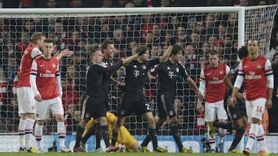 Bayern Munich players celebrate Thomas Muller's goal against Arsenal.