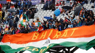 Fans unfurl a huge flag as rain stops play. Action Images via Reuters