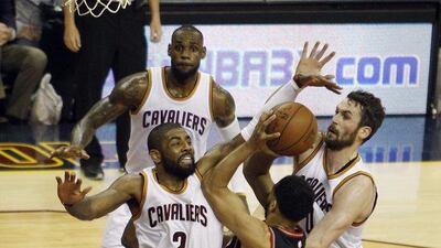 Toronto Raptors guard Cory Joseph, centre, is defended by Cleveland Cavaliers guard Kyrie Irving, left, and Cleveland Cavaliers forward Kevin Love, right, as Cleveland Cavaliers forward LeBron James, back, watches during the second half of the NBA Eastern Conference finals basketball Game 1 at Cleveland. David Maxwell / EPA