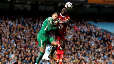 Sadio Mane, right, saw red for catching Manchester City goalkeeper Ederson in the face with a high boot. Lee Smith / Reuters