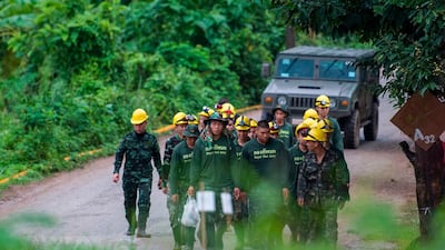 Thai soldiers walk out from the Tham Luang cave area. The rescue operation to save the remaining nine members of a football team enters its second day. AFP