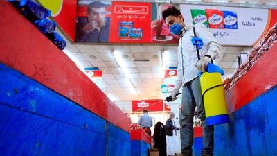 An employee disinfects a supermarket in the Yemeni capital Sanaa. AFP