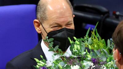 Olaf Scholz receives flowers after being elected Germany's new chancellor. Reuters
