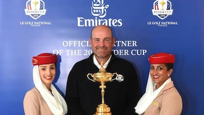 Emirates Cabin Crew and Thomas Bjørn, the European Ryder Cup Team Captain pose with The Ryder Cup. Courtesy Emirates