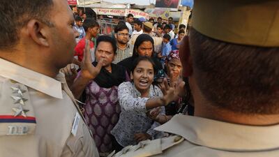 Women shout at policemen near the house of a two-year-old girl who was raped in New Delhi on Friday. Rajat Gupta / EPA