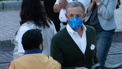 Bob Iger, chairman of Walt Disney Company, elbow-bumps an employee during the reopening of the Disneyland theme park in Anaheim, California, US, on Friday, April 30, 2021. Bloomberg