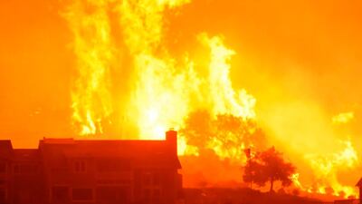 Fames advance on homes off Shepard Mesa Road in Carpinteria, California. Mike Eliason / Santa Barbara County Fire Department via AP