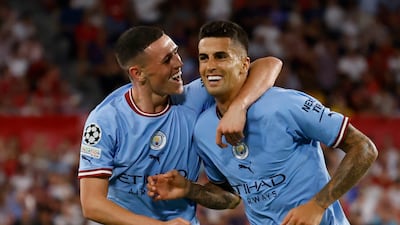 Phil Foden celebrates scoring City's second goal with Joao Cancelo. Reuters