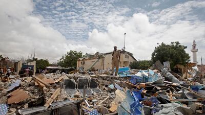 A Somali police officer stands on top of the rubble from a destroyed building after an Al Shabab attack in Mogadishu on September 10, 2018. AP Photo