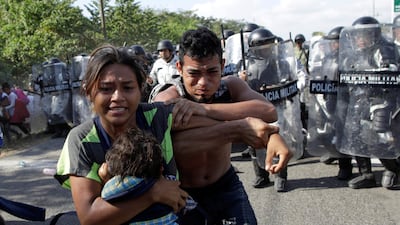 Migrants react as members of the security forces approach to them, near Frontera Hidalgo, Chiapas, Mexico. Reuters