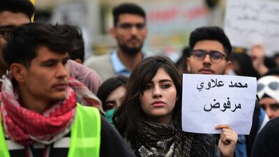An Iraqi university student carries a placard reading in Arabic 'Mohamed Allawi is rejected' during a strike and protests in central Baghdad. EPA