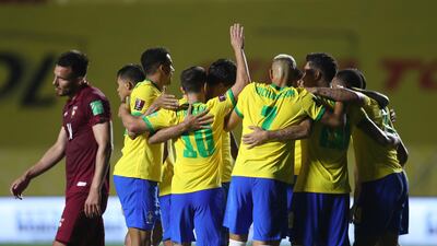 Brazil's Roberto Firmino celebrates with teammates after scoring his side's goal against Venezuela. AP