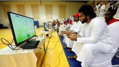 Contestants in the Million Player Playstation Football tournament in Dubai yesterday, all hoping to land the Dh1 million first prize . Satish Kumar / The National