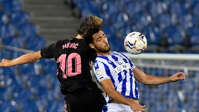 Real Sociedad's Mikel Merino jumps for the ball against Real Madrid's Luka Modric. AP Photo