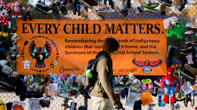 A student walks past a display at Hillcrest High School on Canada's first National Day for Truth and Reconciliation, honouring the lost children and survivors of indigenous residential schools in Ottawa, Ontario. Reuters