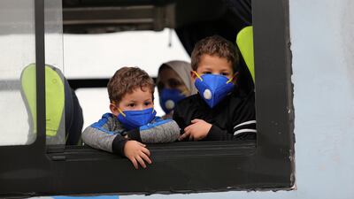 Children wearing protective face masks are pictured on a bus in Algiers, Algeria. Reuters