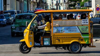 An electric-powered tricycle riding along a street of Havana. Cubans are opting for motorcycles, tricycles and electric cars in the face of the public transportation and fuel shortage crisis. AFP
