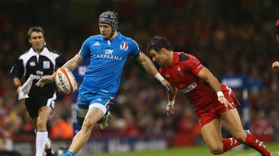 Michele Campagnaro of Italy kicks ahead as Mike Phillips of Wales challenges during the RBS Six Nations match between Wales and Italy at the Millenium Stadium on February 1, 2014 in Cardiff, Wales. (Photo by Michael Steele/Getty Images)