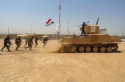 Volunteer fighters from the Imam Ali Brigade, an armed faction with the Iraqi Popular Mobilisation Forces, train at their camp in Najaf. AP, file
