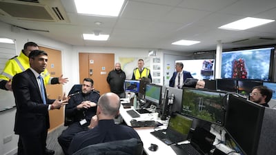 Mr Sunak talks to officials his visit. PA