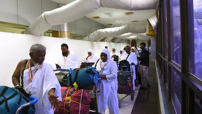 Indian Haj pilgrims form a queue as they prepare to board an aircraft at Sadar Vallabhbhai Patel International Airport in Ahmedabad on August 13, 2017, to undertake the Haj Pilgrimage to Mecca in Saudi Arabia. Sam Panthaky / AFP
