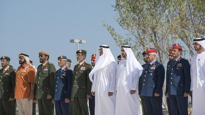Sheikh Mohammed bin Zayed, Crown Prince of Abu Dhabi and Deputy Supreme Commander of the UAE Armed Forces, fifth right, observes a moment of silence during the Commemoration Day flag raising ceremony at Wahat Al Karama. He was joined by Lt General Hamad Al Romaithi, Chief of Staff UAE Armed Forces, sixth right, Major General Essa Saif Al Mazrouei, Deputy Chief of Staff of the UAE Armed Forces, seventh right, Staff Major General Juma Al Bowardi, Commander of the UAE Armed Forces Land Forces, eighth right, Major General Abdullah Muhair Al Ketbi, second left, and others. Mohamed Al Hammadi / Crown Prince Court - Abu Dhabi