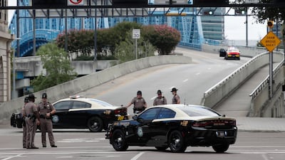 Florida Highway patrolmen block the entrance to the Main Street Bridge near the scene of a mass shooting at Jacksonville Landing. AP Photo