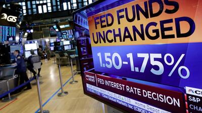 A screen on the floor of the New York Stock Exchange shows the rate decision of the Federal Reserve, on Wednesday. Richard Drew / AP Photo