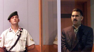 In this June 29, 1999 photo, Kurdish rebel leader Abdullah Ocalan (right) stands next to a Turkish gendarme during his trial on the prison island of Imrali, Turkey. Abdurrahman Antakyali, Anatolia, File/AP Photo