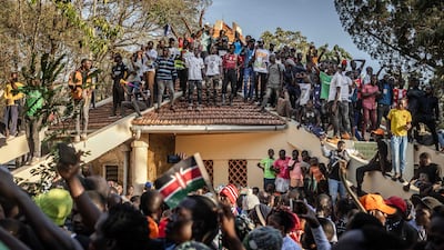 After breaking through security lines, supporters of former PM Raila Odinga mark his death at the tomb of his father, in Bondo, western Kenya.