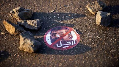 A sticker urging the Egyptian president Mohamed Morsi to leave lies near the presidential palace in Cairo yesterday. Gianluigi Guercia / AFP