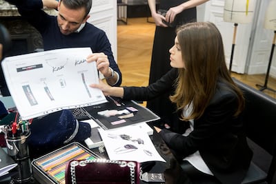 Kaia Gerber overlooks sketches for the collection
