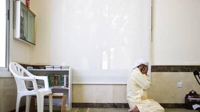 Imam Taha Abdul Razak prays at midday at the Shams Abdul Raheem Mosque in Al Safa.