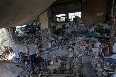 A Palestinian inspects a damaged UNRWA school following an Israeli air strike in Al Nuseirat refugee camp. EPA