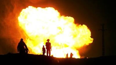 Egyptian Bedouins watch as smoke and flames rise into the air after masked gunmen blew up a terminal of the Egyptian natural gas pipeline to Israel and Jordan in El Arish, in the northern part of Egypt's Sinai Peninsula in July.