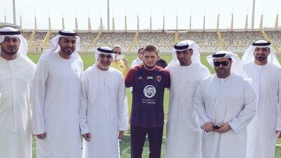 UFC lightweight champion Khabib Nurmagomedov poses with Al Wahda FC officials at the club's Al Nahyan Stadium in Abu Dhabi. Courtesy Al Wahda FC