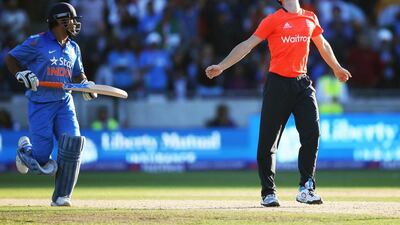 Chris Woakes, right, of England celebrates victory afer he bowled the last ball of the match to MS Dhoni of India during the Twenty20 international match at Edgbaston on September 7, 2014, in Birmingham, England. Clive Mason / Getty Images