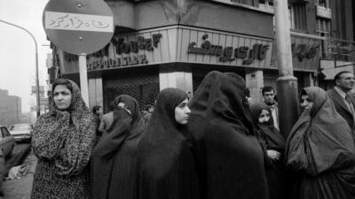 Chador-clad women stand in front of a 'Shah ran' slogan sprayed on a street sign in Tehran a few days after the Shah fled the country, on January 19, 1979. Getty Images