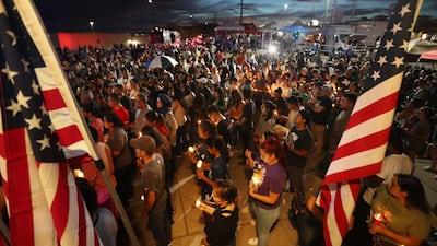 People hold a candlelight vigil for victims of the terrorist attack at El Paso in Texas. AFP