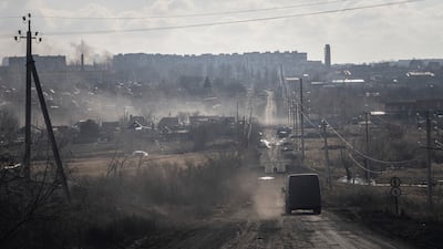 A Ukrainian police van drives on the highway used to evacuate civilians in Khromove near Bakhmut. AP