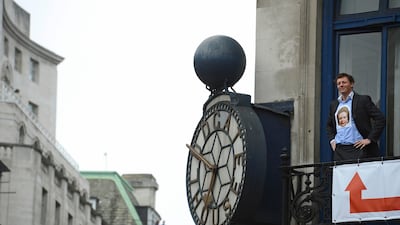 A man gets a view of the funeral on a balcony in London. Paul Hackett / Reuters