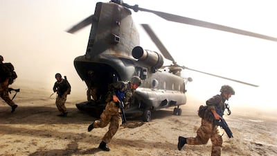 British Royal Marines scramble out of a Chinook helicopter in south-eastern Afghanistan in 2002. All photos: Getty Images