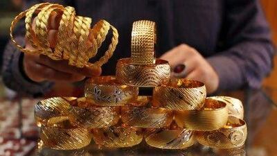 A goldsmith displays gold bangles in his jewellery shop in Istanbul.