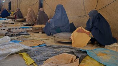 Afghan women workers prepare bread to sell in a market in Kandahar. AFP