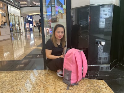 Barsha resident Jane Pasil charges her phone at Mall of the Emirates. Sarwat Nasir / The National